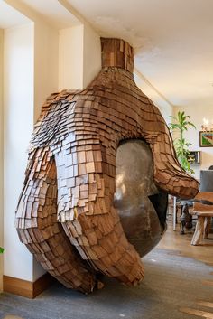 a large wooden sculpture sitting in the middle of a room