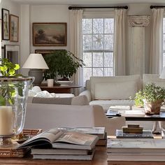 the living room is clean and ready for guests to come home with some books on the coffee table