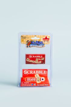 two different types of scrabble game pieces in plastic packaging on a white background