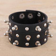 Add some edge to your outfit with Indian artisan Deepika Lohani's studded cuff bracelet. Designed for both men and women, the cuff is hand crafted from wide strips of black leather and embellished with nickel-plated iron studs. Two row of snap buttons let you adjust the size to fit your wrist. Leather Bracers, Leather Cuffs Bracelet, Studded Leather, Leather Cuffs, Cuff Bracelet, Wrap Bracelet, Cuff Bracelets, Black Leather, Jewelry Bracelets