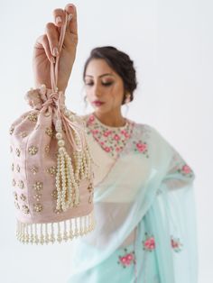 This is a three-piece light blue floral saree set from the Suruchi Parakh collection. The light blue floral saree is paired with an embroidered off-white blouse. The blouse has padding and a back hook opening with a cut-out detail. There are beautiful floral motifs of zardozi, pearl and thread work all over the blouse and saree. This saree set is crafted in soft organza and tussar silk fabrics. The outfit is completed with an inner skirt for the saree.
Clutch NOT included. Blue Floral Saree, Floral Saree, Silk Fabrics, Thread Work, Floral Motifs, Custom Tailoring, White Blouse, Three Piece, Blue Fabric