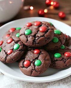 chocolate cookies decorated with candy on a white plate