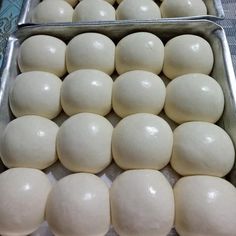 several pans filled with dough on top of a table