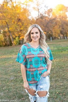 Classic tee gets a little western in this casual beauty! In shades of turquoise and red, this pretty number is perfect for layering or a simple any day tee. 100% Polyester Casual Turquoise Top For Spring, Turquoise Short Sleeve Tops For Spring, Turquoise Casual Summer Tops, Casual Turquoise Tops For Summer, Turquoise Crew Neck T-shirt For Summer, Turquoise Short Sleeve Top For Summer, Turquoise Relaxed Fit Short Sleeve Top, Turquoise Short Sleeve Top With Relaxed Fit, Turquoise Short Sleeve Top Relaxed Fit