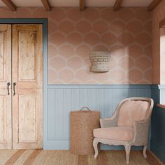 a chair sitting in front of a wooden door next to a basket on the floor