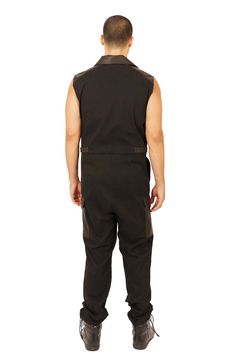 Festival streetwear takes a new shape with the Black Market, mens black jumpsuit. Our boiler suit for men was made for seamless transitions from Friday night drinks to warehouse raves. FEATURES: Made with medium weight, dead stock canvas thats super soft to the touch Accents in goatskin leather Asymmetrical zipper front unzips to reveal leather lapels 6 pockets: 2 zip pockets at the chest, 2 at the hips and 2 cargo pockets above the knee Adjustable waist straps with snaps Sleeveless Flight suit Black Overall Jumpsuit For Streetwear, Black Overall Jumpsuits And Rompers For Streetwear, Black Fitted Utility Overalls, Fitted Black Utility Overalls, Fitted Streetwear Jumpsuits And Rompers, Fitted Utility Overalls, Fitted Streetwear Jumpsuits And Rompers Overall, Fitted Streetwear Jumpsuit Overall, Fitted Overall Jumpsuits For Streetwear