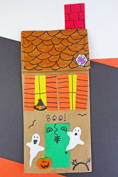 a cardboard house with halloween decorations on it