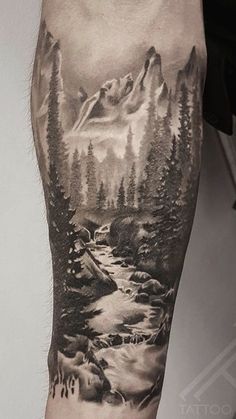 a man with a mountain landscape tattoo on his arm