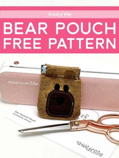 a pair of scissors sitting on top of a pink bag with a bear pouch free pattern