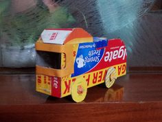 a close up of a toy truck made out of candy bars on a wooden table