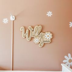 a baby's room with pink walls and white flowers