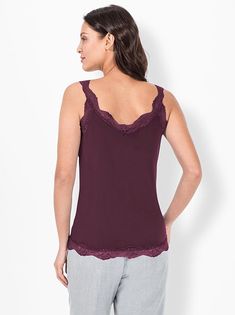 This top is a perfect, sophisticated bottom layer for cardigans, jackets, and more! It features lace at the neckline, on the straps, and at the hem. Elastic, slightly shimmering fabric. Length approx. 26 inches (misses). 95% polyester, 5% elastane. Lace: 95% polyamide, 5% elastane. Machine washable. Imported. Layering Tops With Lace Trim And Spaghetti Straps, Spaghetti Strap Tops With Lace Trim For Layering, Spaghetti Strap Tops With Lace Trim, Lace Trim Spaghetti Strap Top For Layering, Elegant Stretch Camisole For Layering, Lace Camisole Top For Layering, Lace Top For Layering, Elegant Tops With Lace Trim For Layering, Elegant Lace Trim Top For Layering