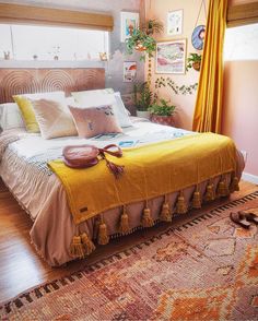 a bedroom with a large bed and yellow curtains