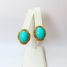 On offer are these Vintage Art Deco Chinese Turquoise Earrings featuring gold gilt over sterling silver filigree work with screw on fittings.  These are large oval earrings measuring 1 inch long x 3/4 inch wide.   In very fine condition for their great age with no damage or repairs but I did find a tiny bit of gilding loss around the top of one of earrings as conducive to their great age. There is no hallmark but they tested positive for sterling silver. A beautiful piece of Chinese history that is no longer being made.  Pictures taken in daylight so you can see  exactly what you will receive. Chinese Art Deco, Oval Earrings, Chinese History, Oval Earring, Sterling Silver Filigree, Silver Filigree, Screw Back Earrings, Art Deco Style, Turquoise Earrings