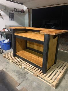 a bar made out of pallets in a garage