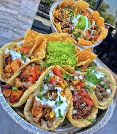 several tacos are on a plate with guacamole and salsa