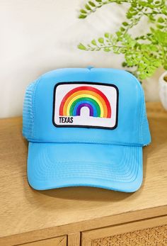 Texas Trucker Hat, blue trucker hat with white patch and rainbow that says Texas under the rainbow Blue Cotton Trucker Snapback Hat, Fun Summer Trucker Hat With Curved Bill, Fun Summer 5-panel Trucker Hat, Summer Fun 5-panel Trucker Hat, Blue Fun Style Snapback Hat, Trendy Blue 5-panel Baseball Cap, Blue Cap With Embroidered Patch, Fun Blue Snapback Hat For Summer, Blue Fun Snapback Hat For Summer