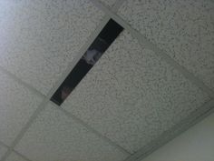 the ceiling in an office building is covered with speckles and black paint on it