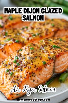 salmon fillets on a white plate with green beans