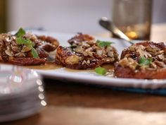 small appetizers on a plate with spoons and water glass in the background