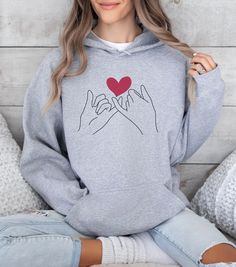 "- **Product Name: Couple Valentines Day Hoodie - \"Pinky Promise\"** - **Material Composition   - Made with a thick blend of cotton and polyester for a plush, soft, and warm feel.   - Medium-heavy fabric (8.0 oz/yd² or 271 g/m²) consisting of 50% cotton and 50% polyester, providing the ideal cozy warmth for chilly days. - **Design Features   - Spacious kangaroo pocket in the front for daily practicality.   - Hood's drawstring is color-matched to the base sweater, adding extra style points. - **Comfortable Fit   - Classic fit for comfort.   - Pouch pocket and tear-away label contribute to a highly comfortable, scratch-free wearing experience. - **Stylish Details   - Color-matched drawcord enhances the overall aesthetic.   - Double-lined hood for added style and durability. - **Ethical Manu Fall Gift Hooded Sweatshirt, Hooded Fall Sweatshirt Gift, Fall Hooded Sweatshirt, Cotton Hooded Hoodie For Gift, Cotton Hooded Hoodie As Gift, Long Sleeve Hoodie With Letter Print For Gift, Winter Gift Hooded Sweatshirt, Hooded Winter Sweatshirt Gift, Winter Gift Hooded Hoodie