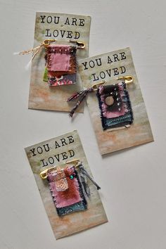 three small tags with words on them that say you are loved