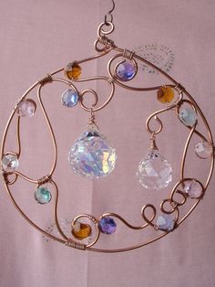 a circular metal object with many different colored glass beads on it's center piece