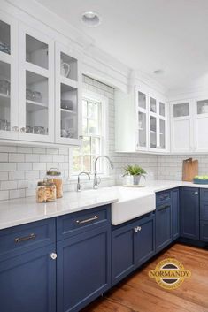 a kitchen with blue cabinets and white counter tops