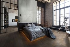 an empty bedroom with large windows and wooden flooring is pictured in this modern apartment