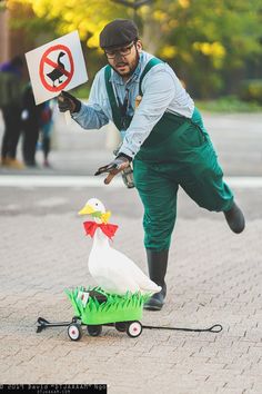 a man is trying to pull a duck out of a toy wagon with a sign on it