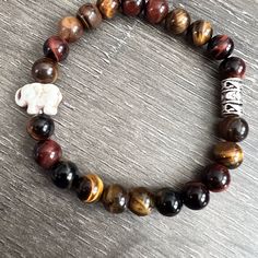 Exquisite Tigers Eye Bracelet With The Cutest Turquoise Elephant Charm. Handmade By Our Family Designers. Gemstone Attributes: Protection, Courage, And Focus. Our Company Donates, One Dollar To The Elephant Reservation For Each Bracelet Purchased. Brown Agate Gemstone Beaded Bracelet, Brown Agate Beaded Bracelet With Gemstones, Brown Agate Casual Jewelry, Casual Brown Agate Jewelry, Brown Gemstone Beads Bracelet As Gift, Brown Gemstone Bracelets For Healing, Brown Gemstone Healing Bracelets, Stretch Bracelet With Round Beads Stones As Gift, Brown Gemstone Bracelet As A Gift