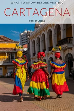 three women in colorful dresses walking down the street with text overlay that reads what to know before visiting cartagena, colombia