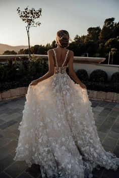 a woman in a wedding dress with flowers on it