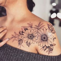 a woman's shoulder with flowers on it