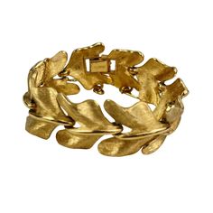 This vintage bracelet is a stunning example of Monets craftsmanship, featuring a gold-tone leaf motif with beautifully textured details. The 7-inch length makes it an elegant addition to any jewelry collection. A piece that speaks of timeless elegance, it is perfect for those who appreciate classic vintage designs. This bracelet has some weight to it and is very well constructed.  * Gold-tone leaf motif * Textured metal * Signed Crown Trifari * 7-inch length * Secure clasp with safety chain Minor wear on the surface, typical of vintage items. Features: * Retro, Vintage, Mid Century, MCM Size: Womens 7 Condition: Pre-Owned Good Vintage Gold Leaf Jewelry, Money Vintage, Crown Trifari, Leaf Motif, Safety Chain, Vintage Bracelet, Bracelet Vintage, Vintage Bracelets, Classic Vintage