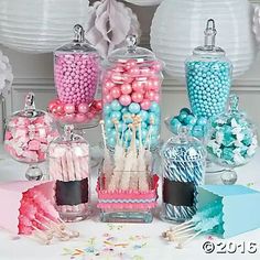 a table topped with lots of candy and lollipops