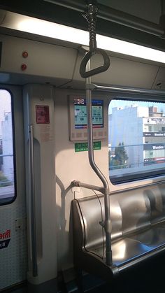 the inside of a subway car with metal railings