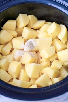 cubed potatoes in a crock pot with sugar on top