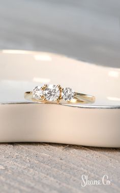 two wedding rings sitting on top of each other