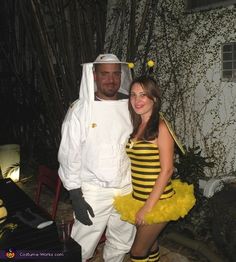 a man and woman dressed in bee costumes