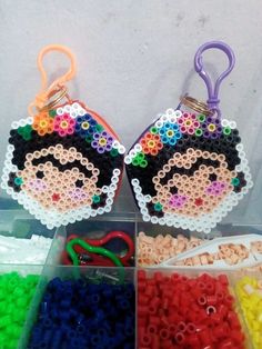 beaded keychains with colorful beads and scissors in plastic case on white background