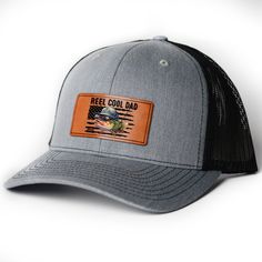 Introducing the "Catch of the Day" Leather Patch Hat! This stylish hat is an essential accessory for any fishing enthusiast. Crafted with a high-quality leather patch that boasts the emblematic fish hook, it's a symbol of both passion and prowess in the fishing community. The rugged, durable design ensures that it stands up to the outdoor elements, whether you're casting lines at dawn or reeling in the big one as the sun sets. MESSAGE: Reel cool dad. PRODUCT DETAILS: Material: Crafted from a high-quality blend of 60% Cotton and 40% Polyester, this hat features a breathable mesh backing. The absorbent cotton sweatband helps keep you cool and dry. Actual size: 23.68". 3 colors available in heather grey/white, heather grey/black and black. Casual Flat Brim Snapback Hat For Fishing, Casual Fishing Trucker Hat With Flat Brim, Black Curved Bill Hat For Fishing, Casual Flat Brim Trucker Hat For Fishing, Black Short Brim Fishing Hat, Black Casual Snapback Hat For Fishing, Adjustable Black Hat For Fishing, Trucker Hat With Flat Bill For Fishing, Casual Trucker Hat For Fishing