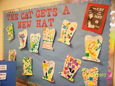 the cat gets a new hat bulletin board is decorated with handprinted mitts