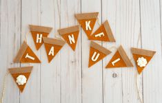 a group of pennants that say thank and have popcorn in them on a white wooden background