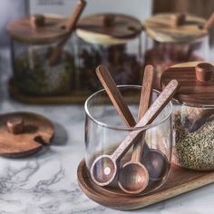 Beautiful acacia wood meets up with glass for a set of food storage jars that are both useful and decorativeFrom spices and seasonings to coffee beans and loose leaf teakeep the items you're always reaching for at the ready in a counter worthy container set that's naturally aestheticStarting with a richwarm toned acacia wood traythree glass jars sit nicely on it and hold over a cup worth of contents per jarEach carved and hand polished acacia wooden spoon sits in the glass container, Handmade Wooden Spoons, Spice Jar Set, Kitchen Containers, Spice Containers, Spice Jar, Glass Storage Jars, Heat Resistant Glass