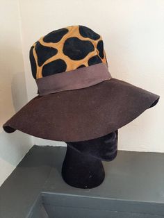 Cool vintage 1960 floppy style ladies hat. Great shape for age. No rips, tears, stains. Brown felt brim with brown grosgrain ribbon around hat. Corduroy black and gold dotted fabric completes the top of hat. Manufacturer is Glenover. Henry Pollack, Inc. New York. Dimensions:  Top patterned area is 4 inches tall. 20 1/2 inches around at base. Saturn Return, Fedora Hat Men, Mode Hippie, Ladies Hat, Cap Mens, Fascinator Hats, Hat For Man, Dotted Fabric, Cool Hats