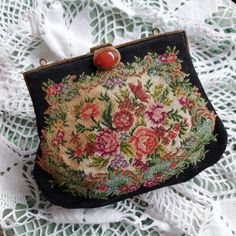 Small vintage tapestry handbag with decorative clasp (without chain). The bag is embroidered in petit point technique. The floral pattern is the same on both sides and also appears on the bottom and sides. Inside the handbag there is a black lining with one small pocket. The perfect thing to decorate your outfit in an elegant retro style. Great for special occasions. * Colours : black and multi-colored * Material : fabric, metal * Shape : as in the photos * Size : width 17 cm (6,7"); length 13 c Elegant Tapestry Bag Suitable For Gift, Elegant Tapestry Bag Perfect For Gifts, Elegant Tapestry Bag As Gift, Handmade Tapestry Bags For Evening, Handmade Tapestry Evening Bags, Elegant Tapestry Bag For Gift, Elegant Tapestry Bags For Gifts, Vintage Floral Embroidery Bags For Formal Occasions, Vintage Floral Embroidered Bag For Formal Occasions