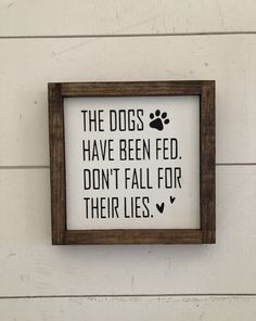 a sign on the wall that says, the dogs have been fed don't fall for their lies