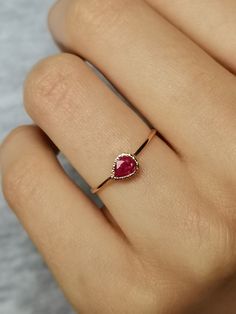 Natural Ruby Ring handcrafted in 14k gold, tear drop ring, 14k gold ring. This is a beautiful ruby ring with tiny heart cut out in the back - 100% handcrafted which can become a wonderful treasure to cherish for years to come. Ruby is July birthstone. CENTRAL STONE: * natural, Earth mined gemstone- ruby * teardrop placed horizontally APPROXIMATE MEASUREMENTS OF THE RING: *band: approximately 1 mm *material: 14k gold (yellow/rose/white) *size- please pick from the drop down menu. If you need othe Rose Gold Ruby Ring As Gift, Rose Gold Ruby Ring Gift, Rose Gold Ruby Diamond Ring Gift, 14k Gold Ruby Ring Gift, Dainty Ruby Ring For Formal Occasions, Dainty Ruby Ring For Promise, Rose Gold Ruby Ring For Promise, Rose Gold Ruby Jewelry For Promise, Rose Gold Ruby Ring With Bezel Setting For Gift