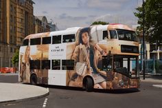 a double decker bus is parked on the side of the road in front of some buildings